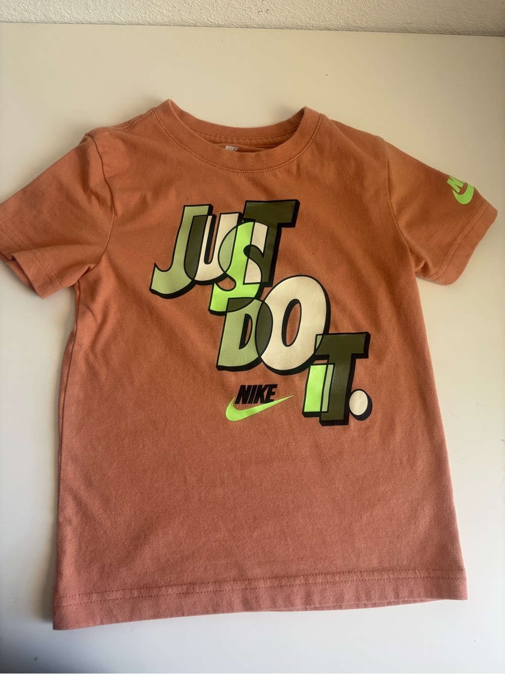 Nike Kids Short Sleeve Tee in Rust with Neon Green Graphic